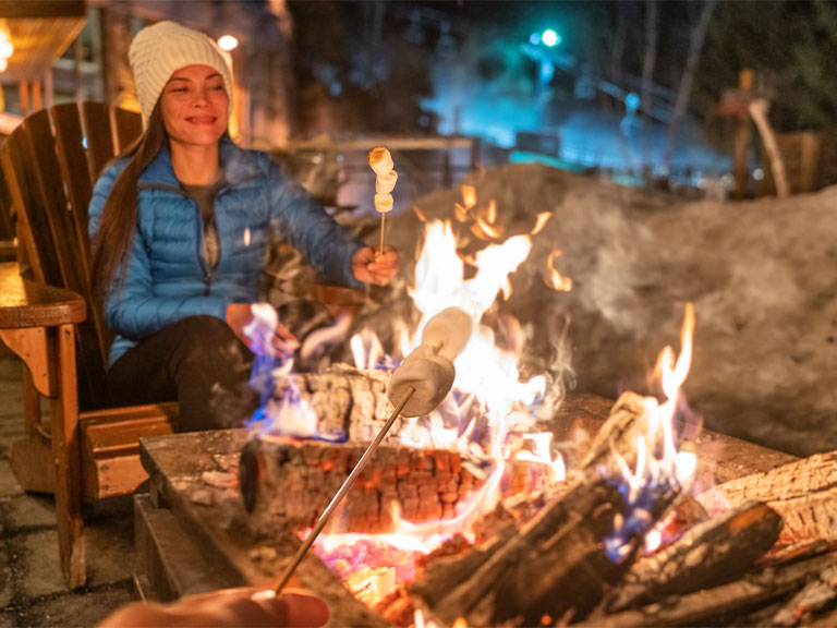 woman-sits-by-fire