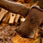 pigeon-forge-rusty-axe-in-log