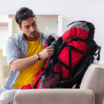 hiker-packing-backpack