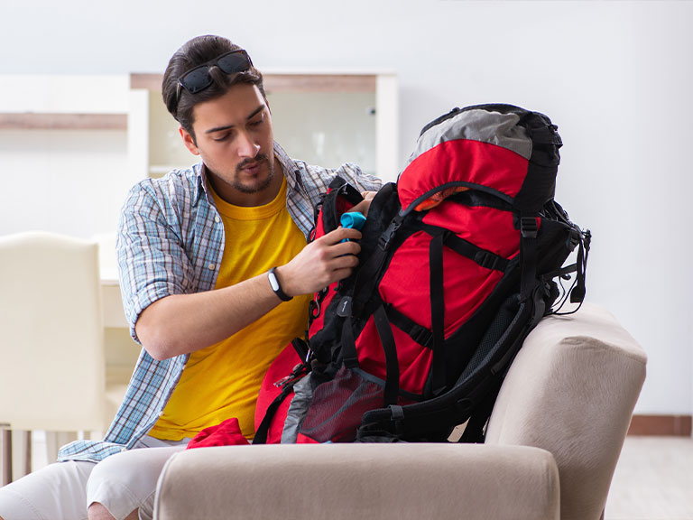 hiker-packing-backpack